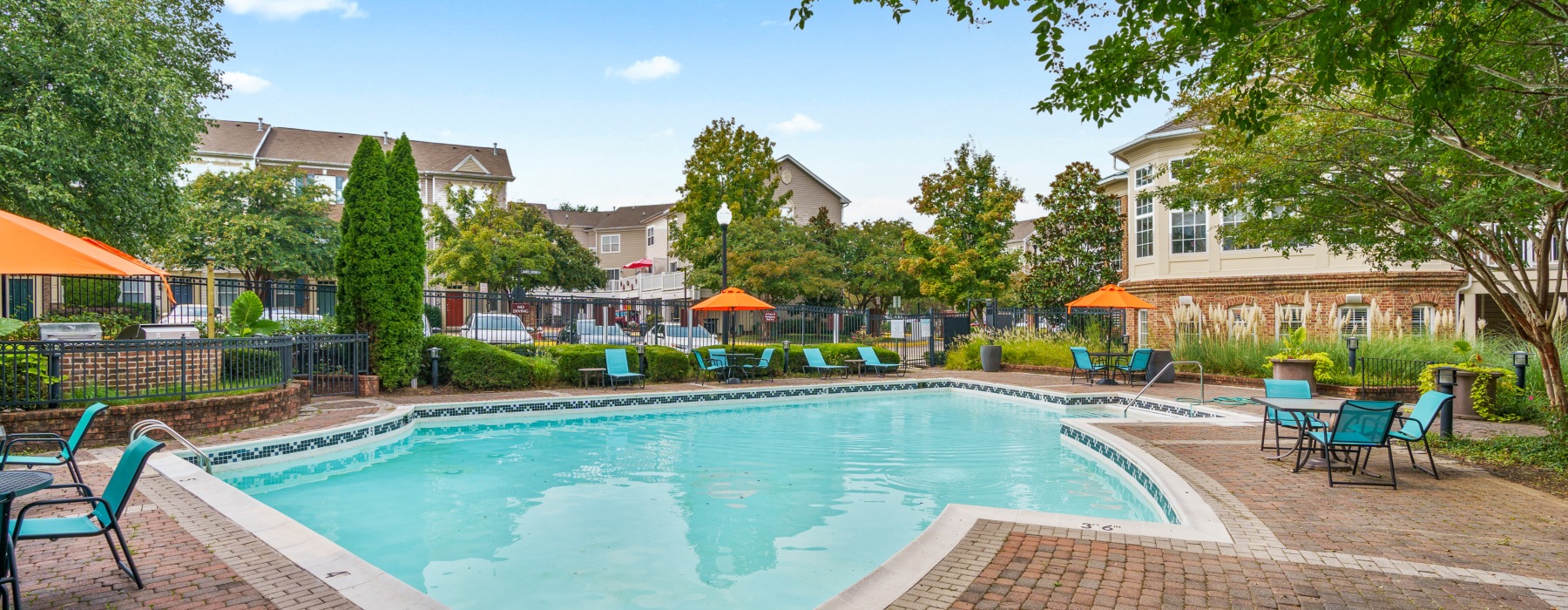 Resort-style swimming pool with lounge seating