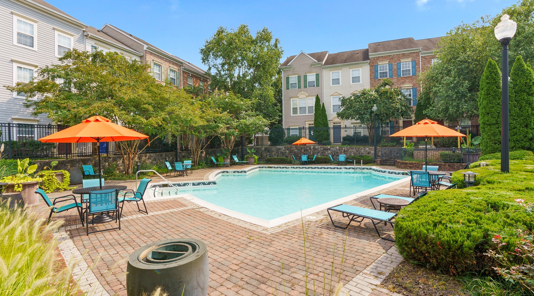 Resort-style swimming pool with lounge seating and lush landscaping